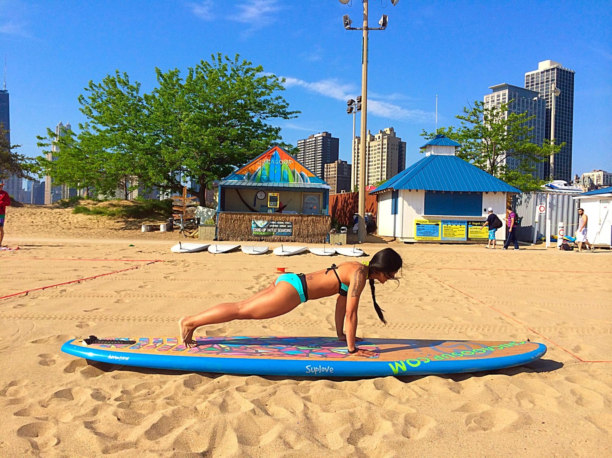 Betina on a stand up paddle board Crosstown Fitness asweatlife fabfitchicago standup paddle board in chicago