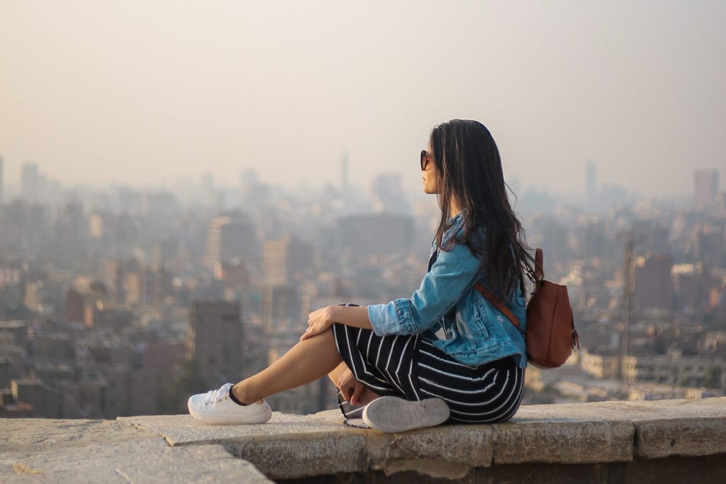 29 things i learned in my 20s woman sitting on a ledge thinking