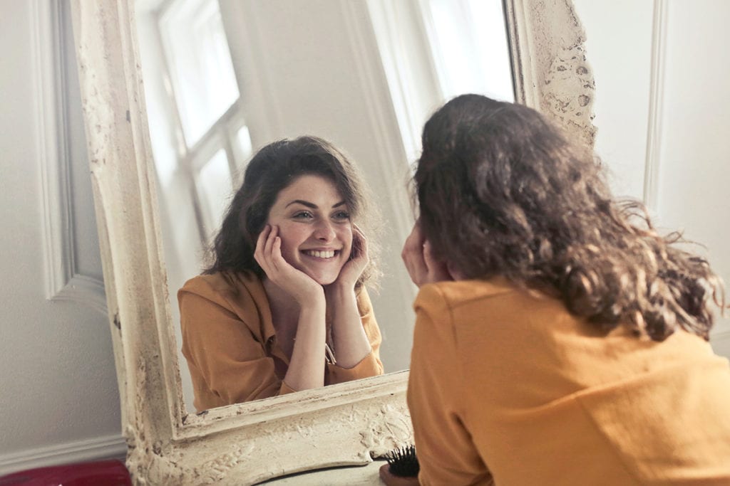 woman looking in the mirror