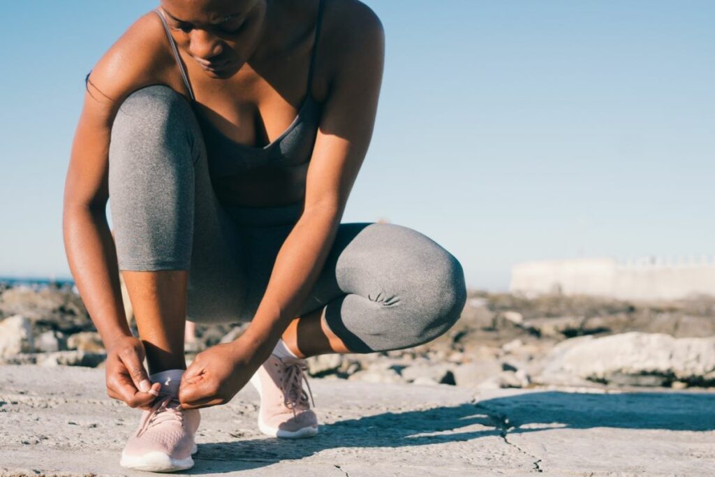 person tying shoes before running