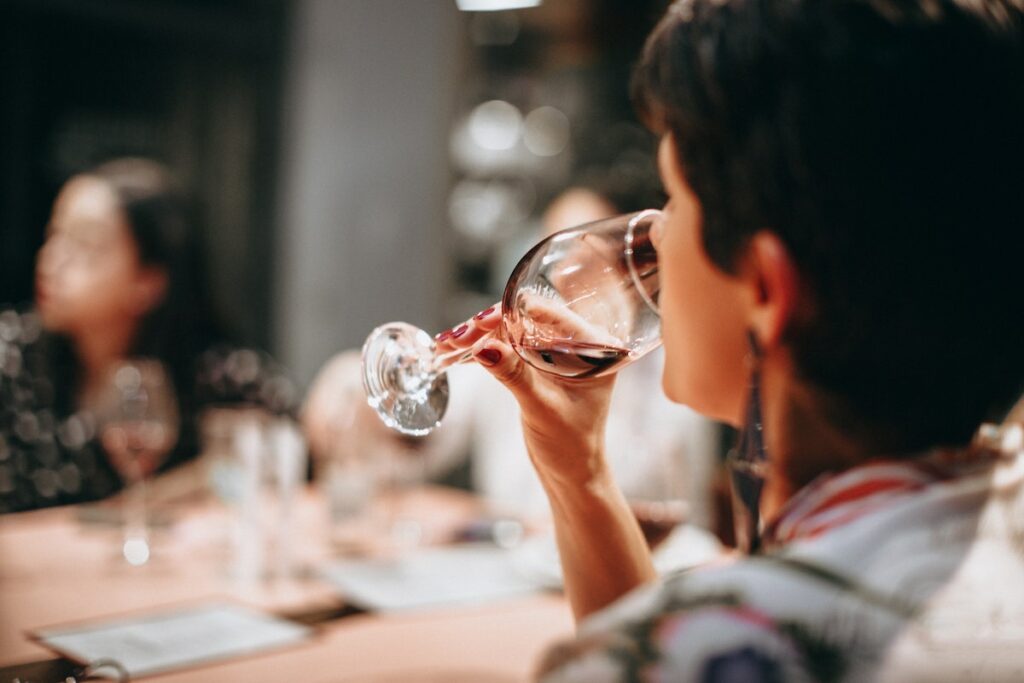 person drinking clean wine