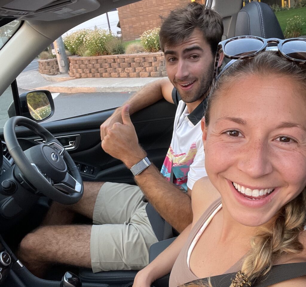 two people smiling inside car