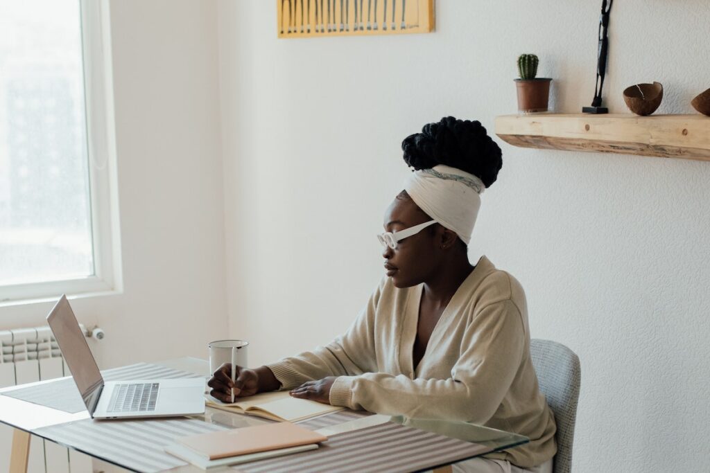 person writing in wellness journal