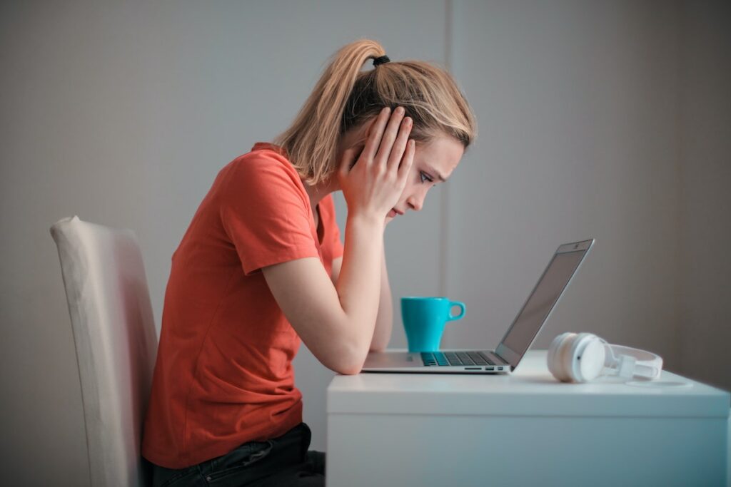 person with hands over ears experiencing noise pollution