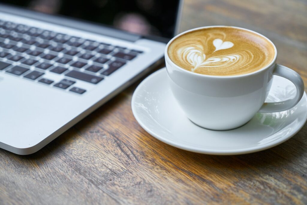 latte next to a laptop