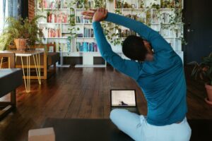 person doing online personal training on laptop