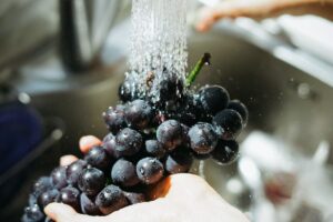 grapes being washed in sink