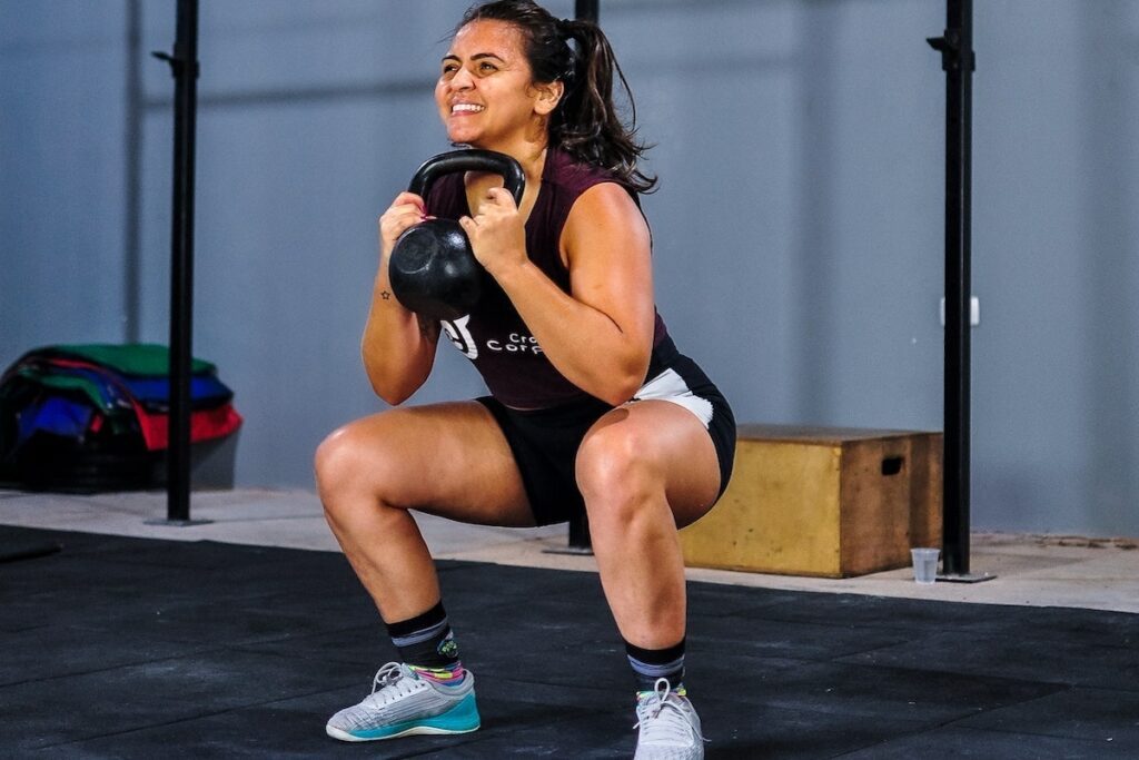 person doing strength training with kettlebell