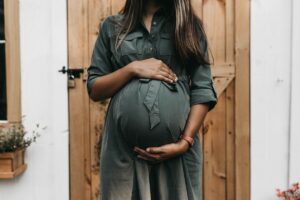 person holding pregnant belly