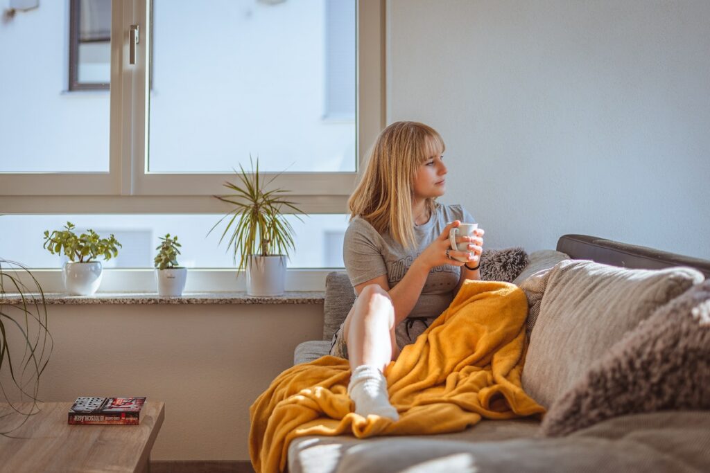 person with yeast infection sitting on couch