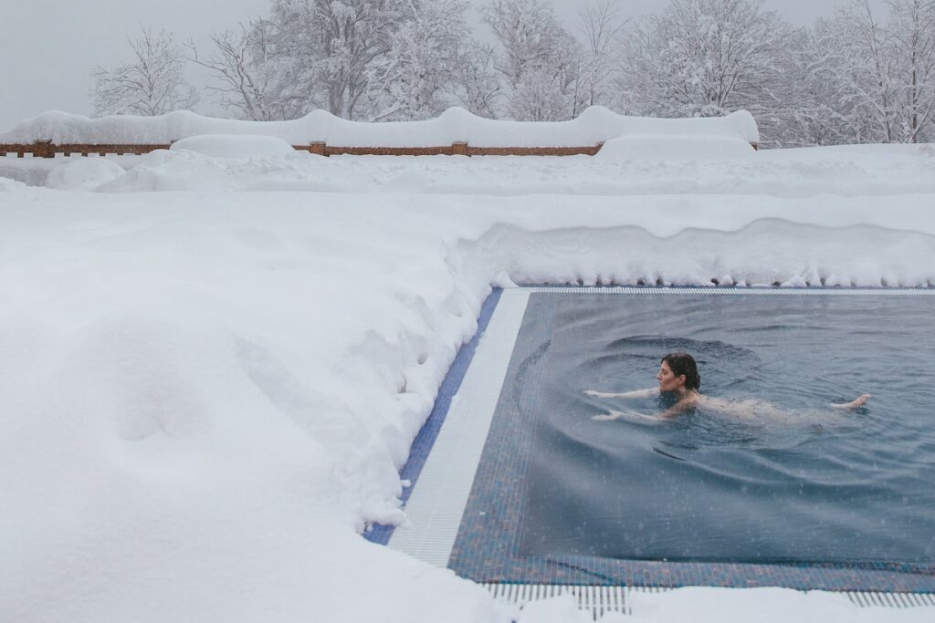 person swimming in cold outside