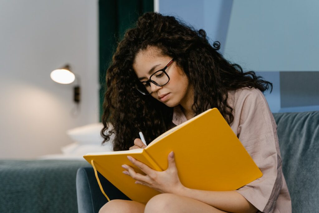 person writing in a gratitude journal