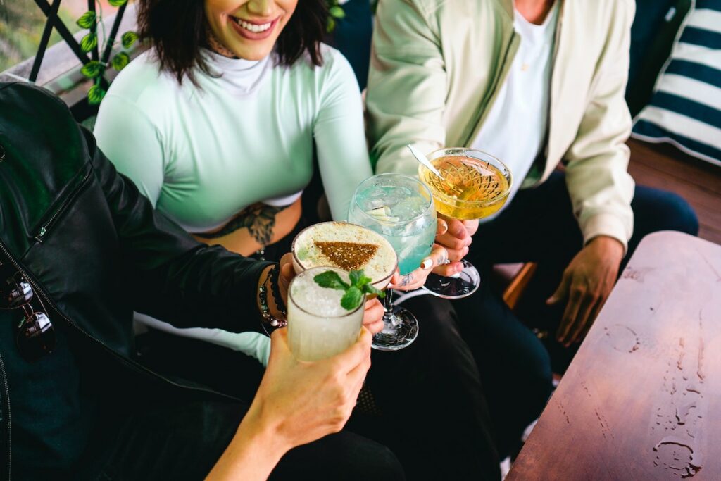 people holding cocktails