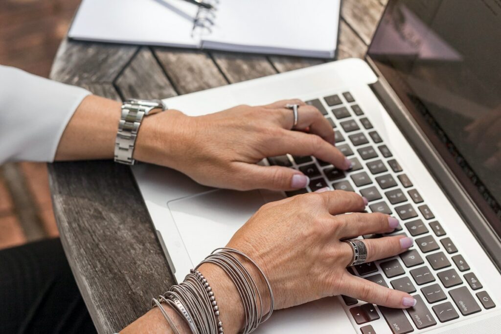 person typing on laptop