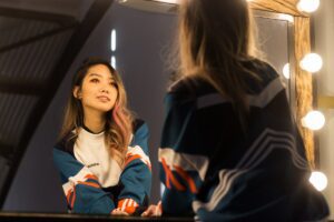 person staring in mirror