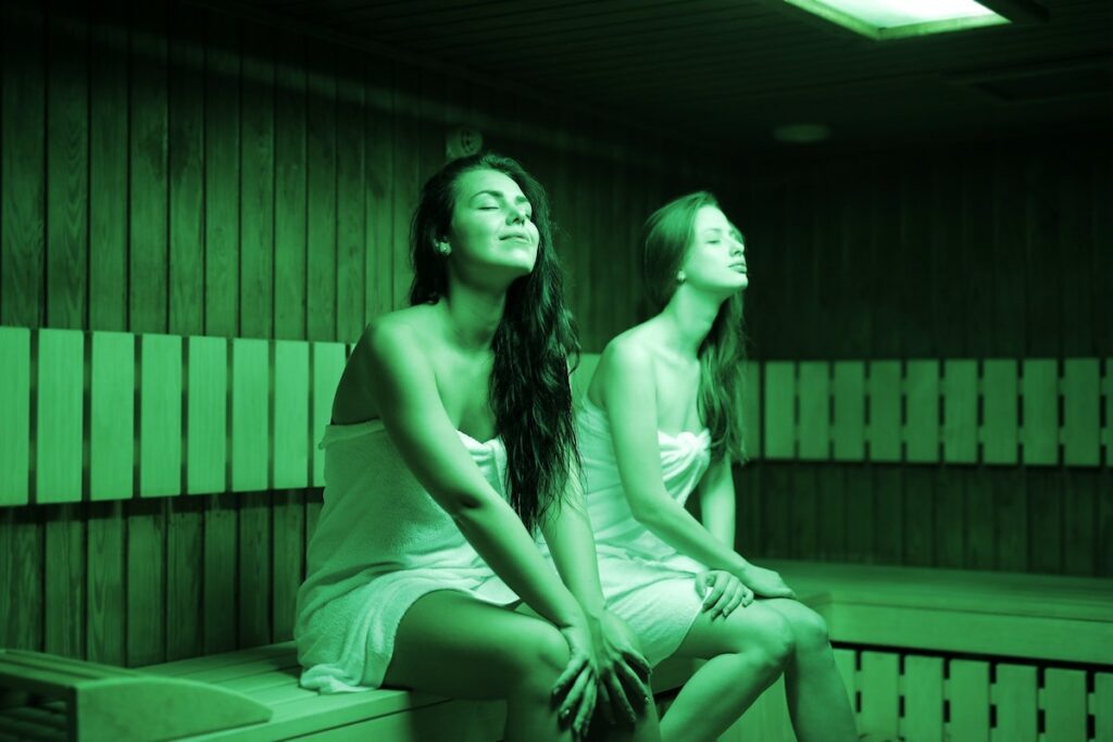 two people sitting in sauna