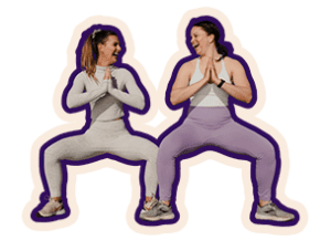 Two friends in a squat position, smiling with hands